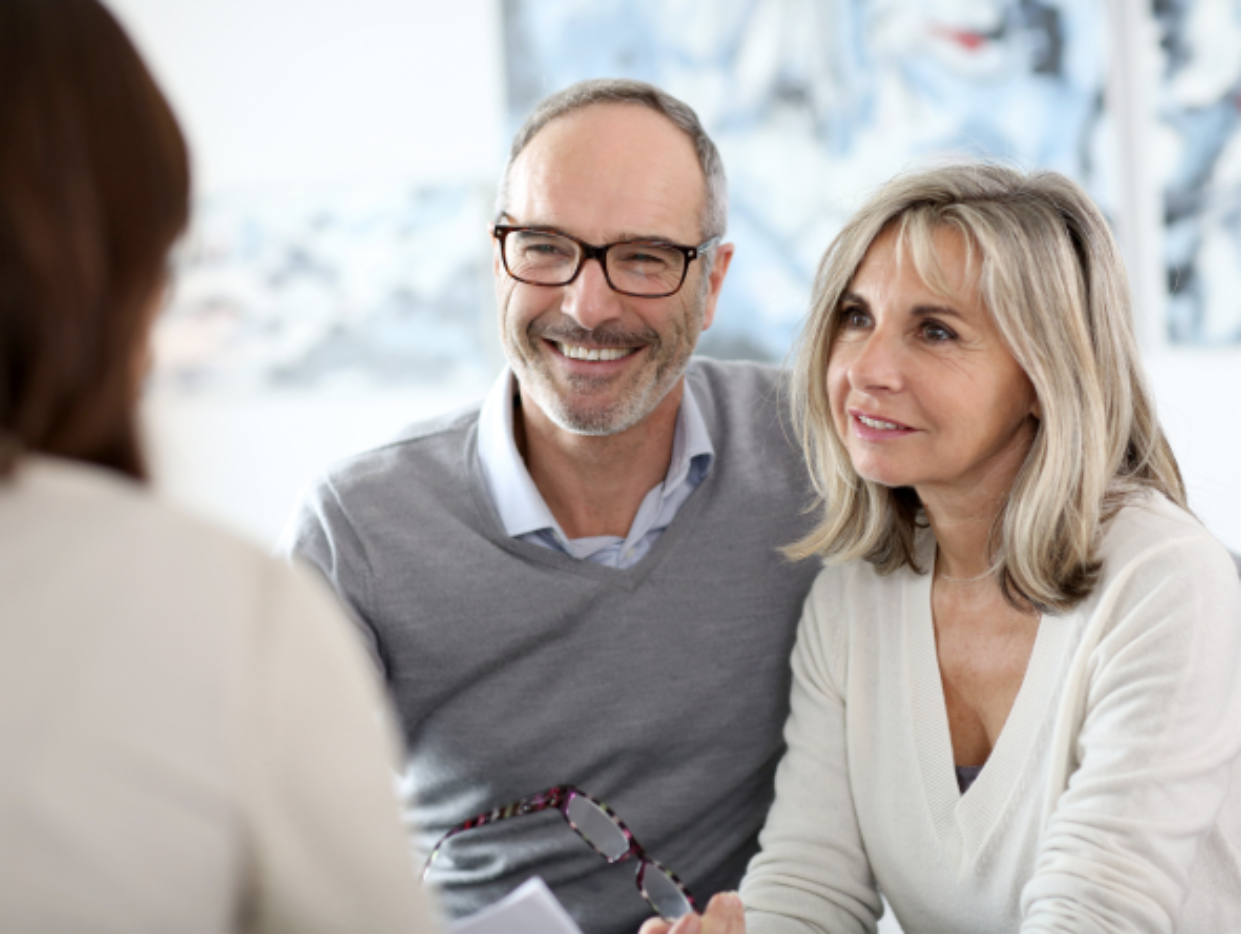 A mature couple who are preparing for retirement by speaking with a Goldco IRA consultant about a self-directed IRA.